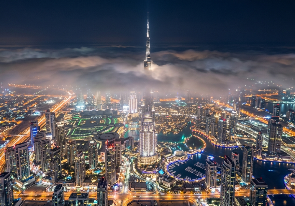 Dubai skyline at night featuring the Burj Khalifa and city lights