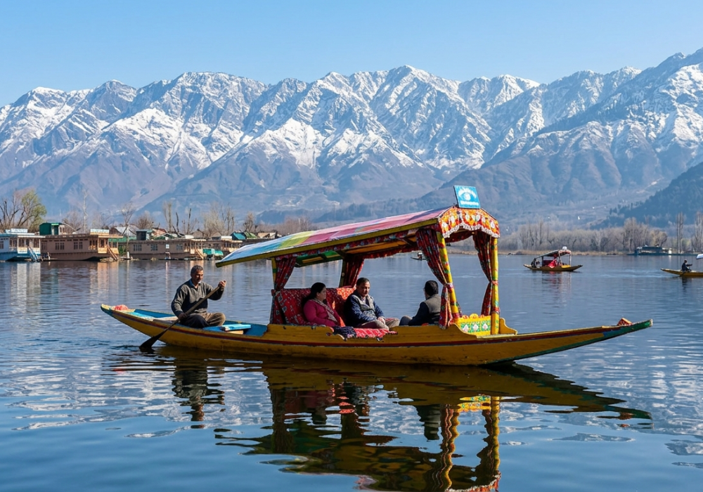 Shikara boat on Dal Lake against snow-capped Himalayan peaks, Kashmir